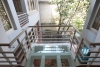 L-shaped modern house with swimming pool in Au Co street